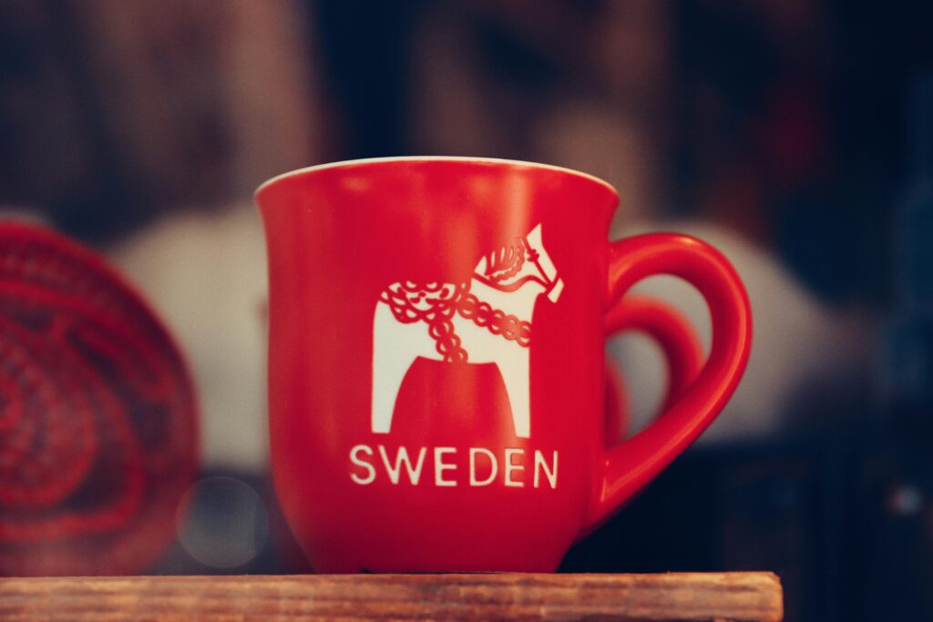 Close-up of a red mug with Swedish Dala horse pattern, photographed in Gränna, Sweden.