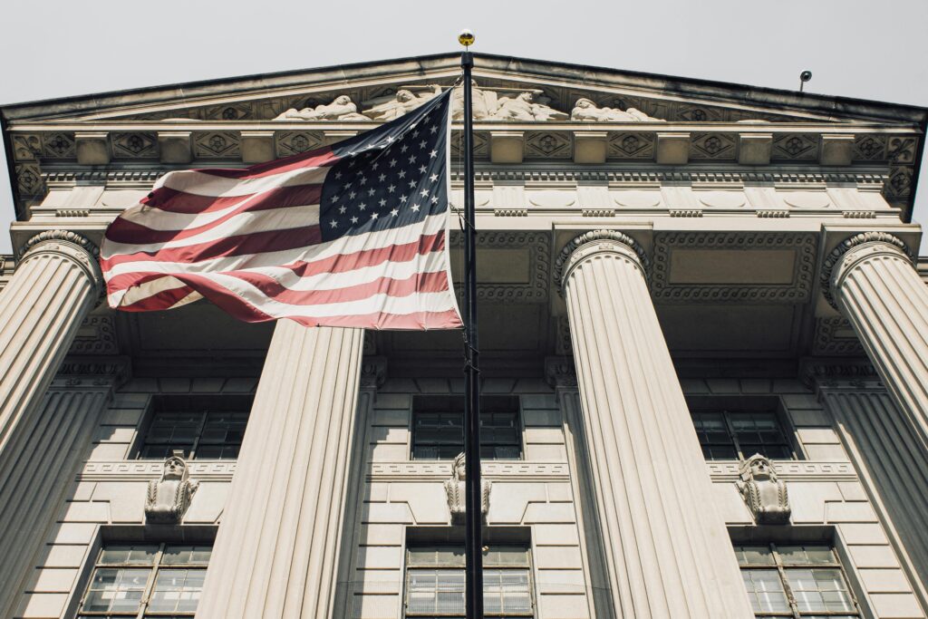 Majestic view of a government building with the American flag waving proudly.